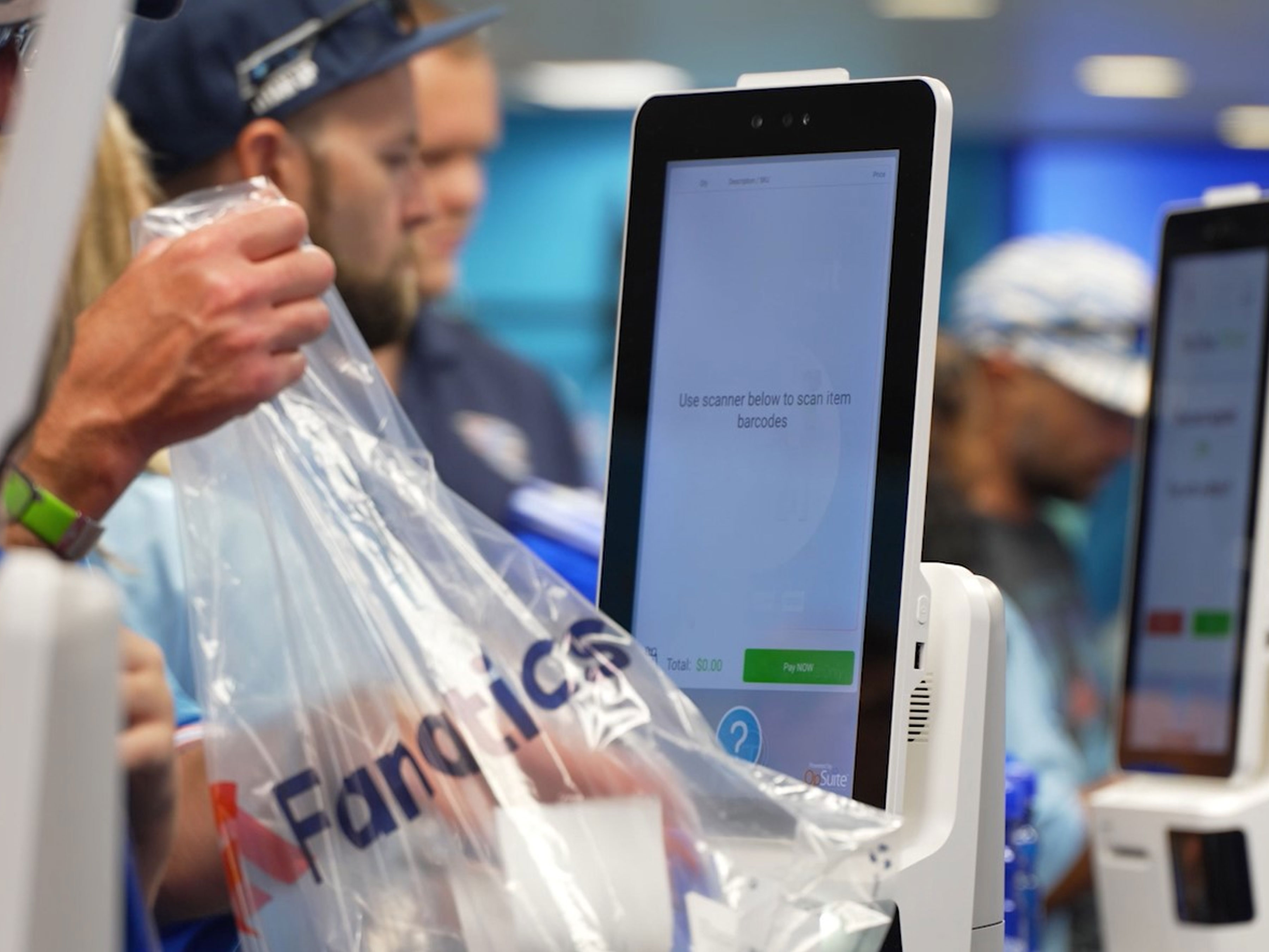 Customers using Zebra's devices at Fanatics store